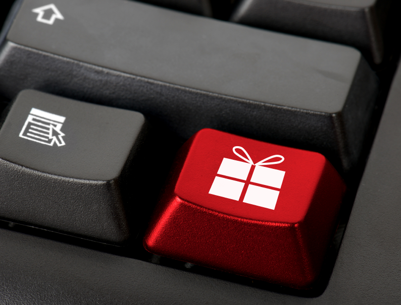 Teclado de ordenador con una tecla roja con el icono de un regalo